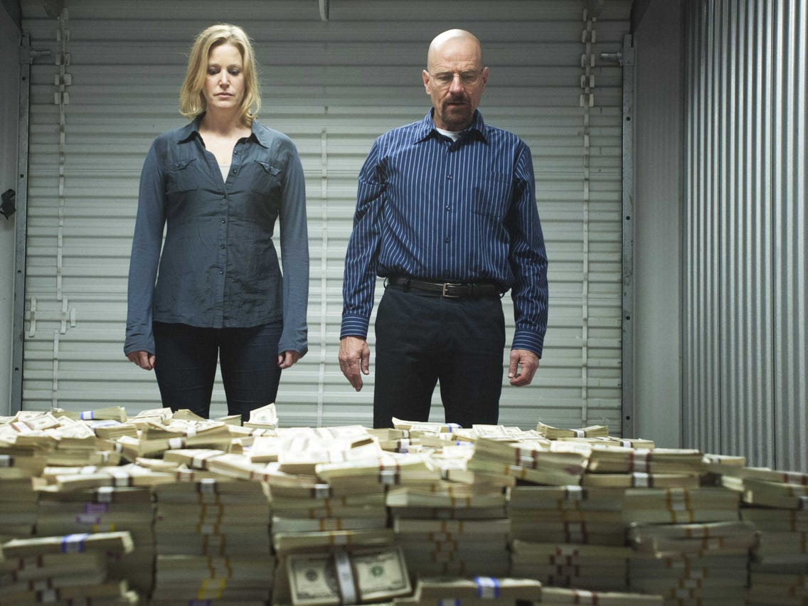walter white standing with his wife by a money pile